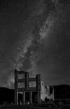 The Milky Way looms over the ruins of the old bank building in Rhyolite NV