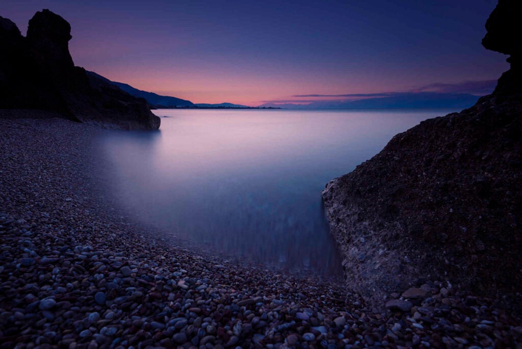 A 64 seconds long exposure seascape during sunset in a remote beach. Beaches during winter is a great place for the seascape photographer, there's only you and the seascape. The sun was well under the horizon at that time. Pounta beach, Aigialeia, Greece.