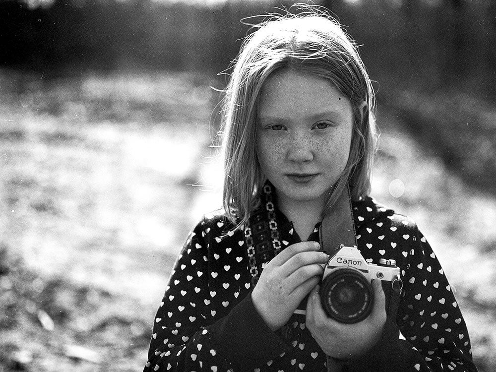 young girl with camera