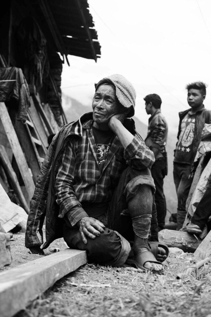 Here is a photo of a survivor the horrible earthquake in Nepal several months ago. His pose and expression reveal how desperate and hurt he is.