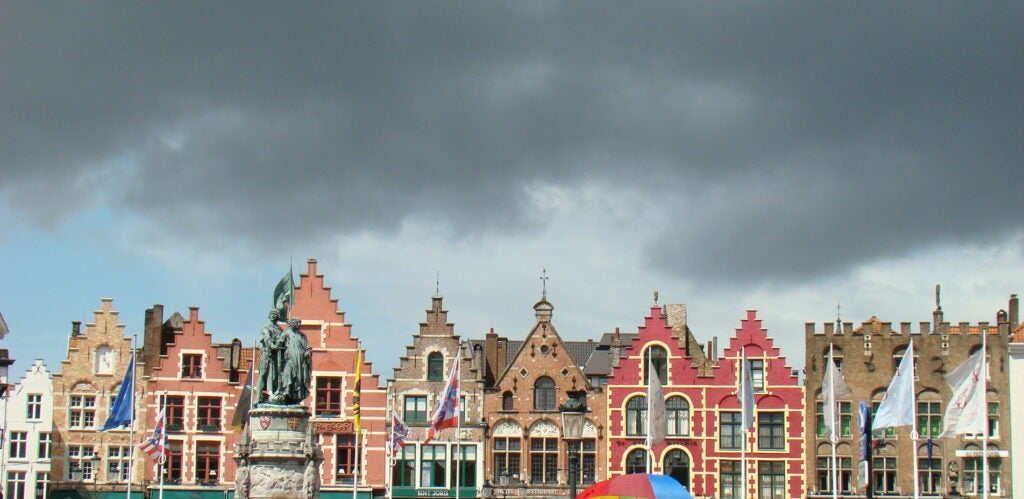 Photo: CLAIRE THORNE Bruges's colorful Grote Markt in Belgium being threatened by storm clouds. CAMERA: Sony DSC-H9