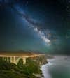 Photo: Christopher Axe I returned to Bixby Bridge after photographing it before in an attempt to include the Milky Way in the image. This time a did a three image panorama. The foreground and bridge was exposed for 5 minutes at f2.8 and ISO 1250 the additional sky images were exposed at f2.8 for 30 seconds at ISO 2000. The light streak is of a south bound car. CAMERA: Canon 5D Mark III FOCAL LENGTH: 14mm SHUTTER SPEED: 5 minutes LENS: Canon 14mm f2.8 L ISO: 1250 APERTURE (F-STOP): f2.8