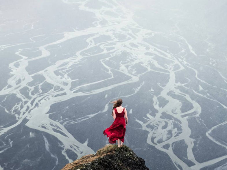 woman in red dress overlooking valley