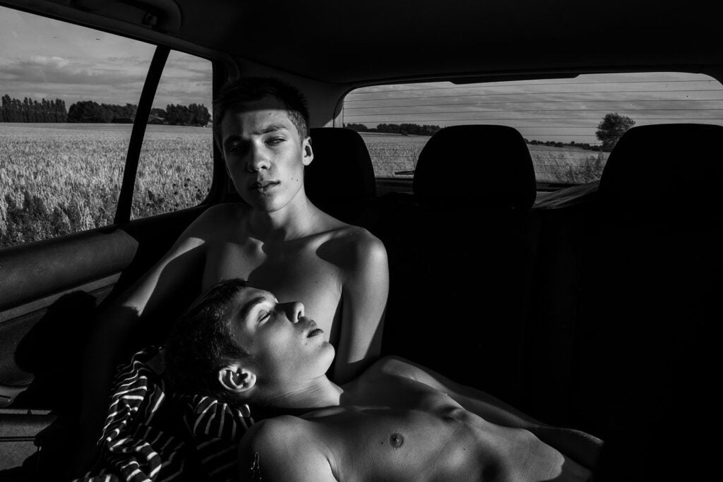 This portrait of two identical twins( Nils and Emil, 15 years old) in Fyn, Denmark, is part of a series of pictures, portraying people who has a strong connection to another person and who often think of themselves as a 'we' instead of 'me'.  The photo is trying to depict the two brothers different role within the family.