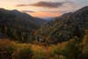 Muted sunset color spills over the Great Smoky Mountains, while early fall colors erupt on the high elevation slopes.