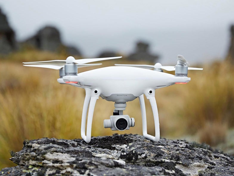 White DJI phantom drone on a rock