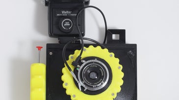Yellow Cameradactyl OG 4x5 hand camera with flash