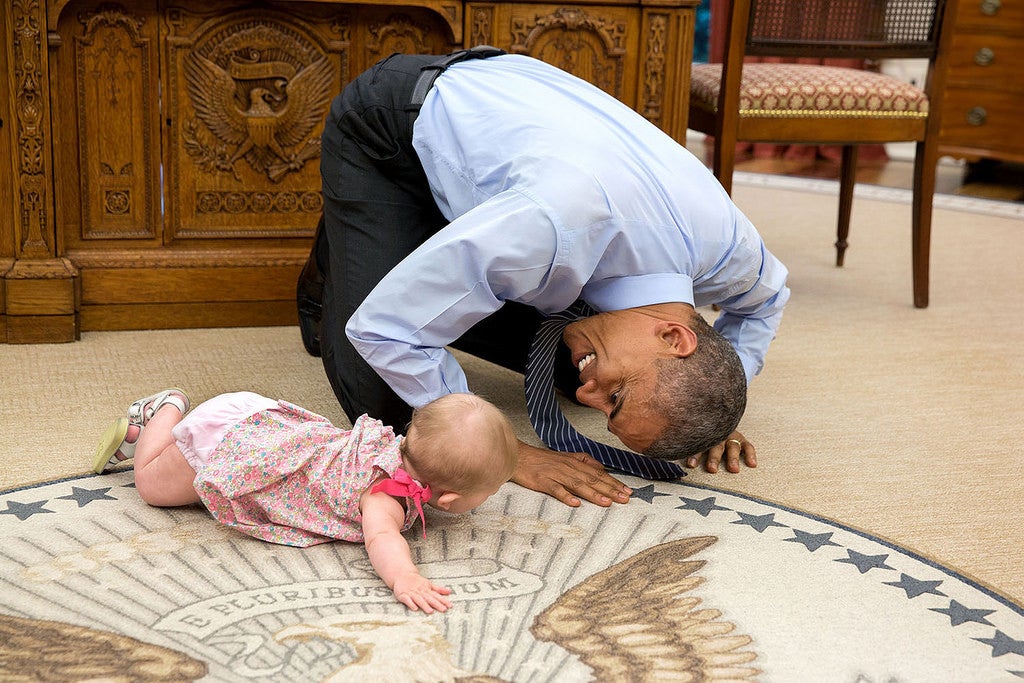 Obama on the floor with baby Ella