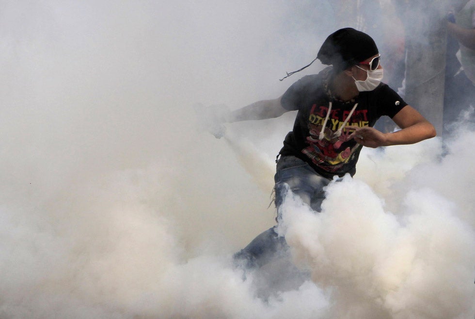An anti-Mursi protester runs to throw a tear gas canister back during clashes with riot police at Tahrir Square in Cairo. Mohamed Abd El Ghany Mohamed Abd El Ghany is a Reuters staffer based in Cairo. He also shoots for the <em>Egypt Independent</em>. See more of his work <a href="http://www.americanphotomag.com/photo-gallery/2012/09/photojournalism-week-september-14-2012?page=7">here</a>.