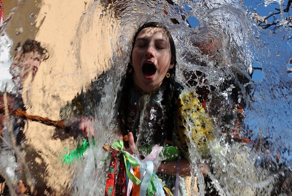 During the Easter season, it is tradition in the Slovakian village of Trencianska Tepla for men to dress in costumes and throw buckets of water on young girls. The tradition is a symbol of youth, strength and beauty for the coming spring season. Samuel Kubani is a general news photographer working for AFP and Getty throughout Europe.