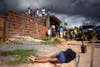 Residents observe the body of an individual killed by street violence in the slums of Salvador, Brazil. Authorities are worried about the 250% increase in murder rate in what is one of Brazil's main tourist cities, as well as a 2014 World Cup host city. Lunae Parracho is a Brazilian-based photojournalist stringing for Reuters. See more of his work <a href="http://www.americanphotomag.com/photo-gallery/2012/10/photojournalism-week-october-12-2012?page=8">here</a>.