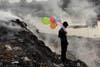 A boy plays with balloons by the Buriganga river in Dhaka, Bangladesh. Andrew Biraj is a Reuters staff photographer based out of Dhaka, Bangladesh and the winner of a 2011 World Press Photo award. See more of his work <a href="http://www.americanphotomag.com/photo-gallery/2013/01/photojournalism-week-january-18-2013?page=5">here</a>.