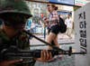 Pedestrians walk past a soldier participating in an anti-terror drill at a subway station in Seoul, South Korea. Kim Hong-Ji is a photojournalist working for Reuters out of South Korea. See more of his work on his <a href="http://kimhongji.net/">personal site</a>.