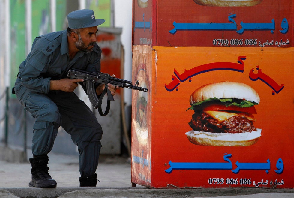 An Afghan policeman takes position at the site of an attack in Kabul. Insurgents fired a rocket-propelled grenade into a house used by British diplomats in the center of the city. Omar Sobhani is Reuters staff photographer based in Iraq, and is no stranger to documenting violence.