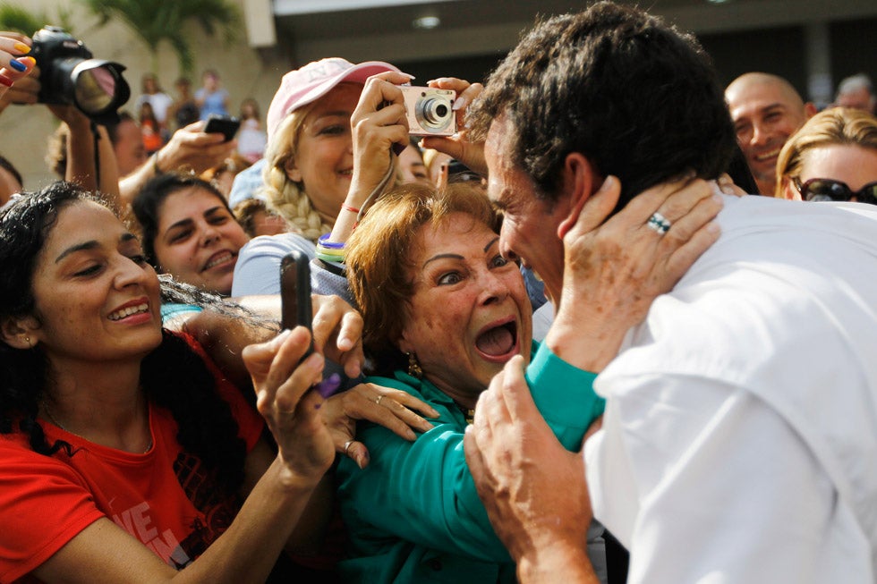 Venezuela's opposition presidential candidate Henrique Capriles is mobbed by supporters after he voted in the presidential election pitting him against President Hugo Chavez. Chavez ultimately won reelection. Carlos Garcia Rawlins is a Venezuela-based photojournalist working for Reuters. Check out more of his incredible work <a href="http://www.photorawlins.com/">here</a>.