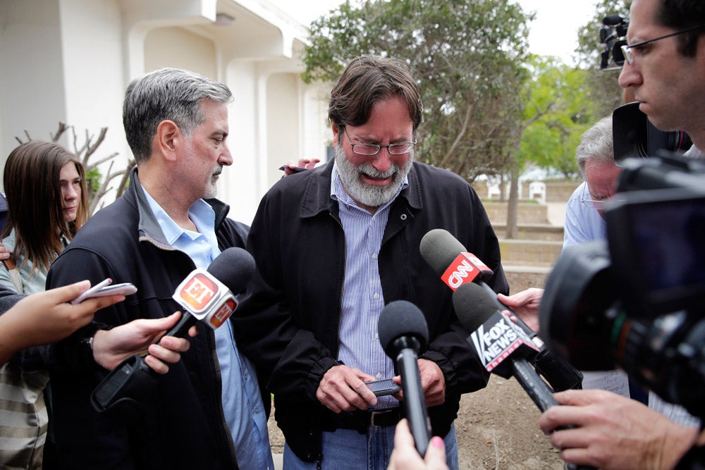 Richard Martinez, center, who says his son Christopher Martinez was killed in Friday night's mass shooting that took place in Isla Vista, Calif., is comforted by his brother, Alan, as he talks to media outside the Santa Barbara County Sheriff's Headquarters. Jae C. Hong is an Associated Press staffer based in Los Angeles, California. He started with the AP in 2005 as an intern and was later hired as a full-time photographer. See more of his images <a href="http://www.apimages.com/Collection/Landing/Photographer+Jae+C.+Hong/f5c063955a424a078c89ce00d8e2e1eb">here</a> and follow his shooting adventures on Twitter <a href="https://twitter.com/jaethephotog">here</a>.