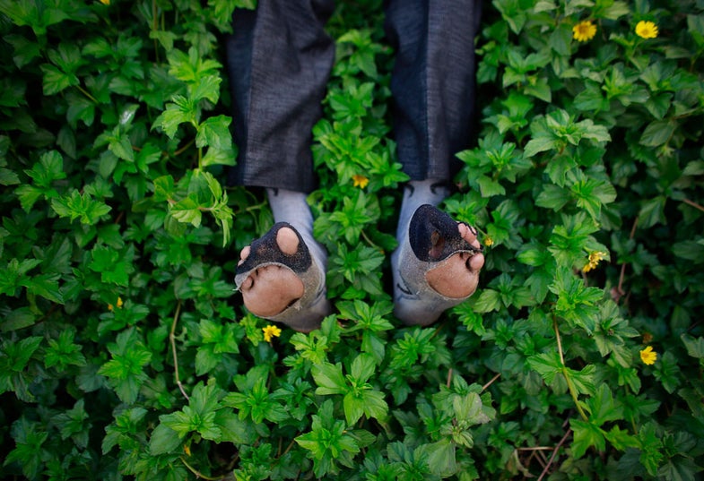 Ram Pratap Verma, a 32-year-old aspiring Bollywood film actor, poses for a photograph wearing his worn out socks on a beach in Mumbai April 16, 2013. Bollywood is an addiction for many; an addiction that attracts thousands of aspiring stars to the city of Mumbai. Ram Pratap Verma made the journey from his small village eight years ago, and despite carrying his whole "home" inside his bag, he is determined not to give up on his ambitions. He endeavours to watch at least one film a week at a cinema, where the silver screen keeps his dreams alive. Picture taken April 16, 2013. REUTERS/Danish Siddiqui (INDIA - Tags: ENTERTAINMENT SOCIETY TPX IMAGES OF THE DAY) ATTENTION EDITORS: PICTURE 8 24 FOR PACKAGE 'DREAMING BOLLYWOOD'. SEARCH 'RAM PRATAP VERMA' FOR ALL - RTXZ84I