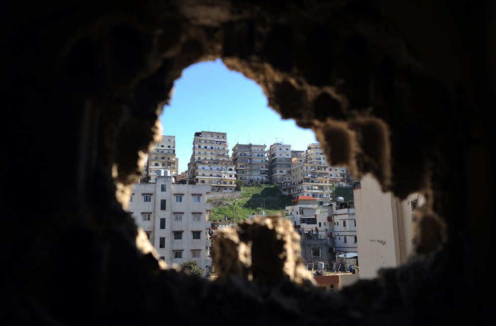 Dimitar Dilkoff, an AFP staff photographer based in Europe, captured this view of the northern Lebanese city of Tripoli through a hole in a building made by a rocket-propelled grenade. For months, Lebanese Sunni Muslims, hostile to Syria’s regime, have clashed with Alawites who support the regime.