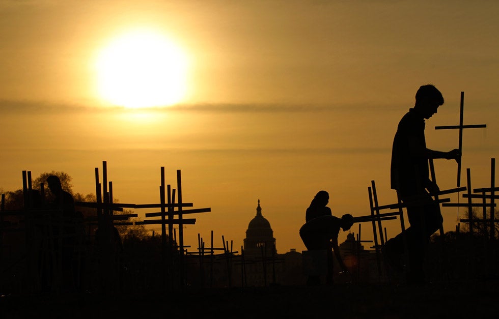 The sun rises above the U.S. Capitol as volunteers place 3,300 crosses, symbolizing grave markers, on the National Mall in Washington, DC. The number 3,300 represents the supposed number of people who have died as a result of gun violence since the tragedy in Newtown, Connecticut. Kevin Lamarque is a senior staff photographer at Reuters and has been with the agency for over 25 years. Check out some of his past images <a href="http://www.americanphotomag.com/photo-gallery/2012/08/photojournalism-week-august-31-2012?page=4">here</a> and <a href="http://www.americanphotomag.com/photo-gallery/2012/08/photojournalism-week-august-24-2012?page=3">here</a>.