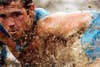 A competitor swims through mud beneath a web of electrified wires during the Tough Mudder race at Mt. Snow in West Dover, Vermont. The Tough Mudder is a nine-mile endurance event that runs competitors through a military style obstacle course. Jessica Rinaldi is a freelance photographer based out of Boston, Massachusetts. See more of her work on her <a href="http://www.jessicarinaldi.com/">personal site</a>.