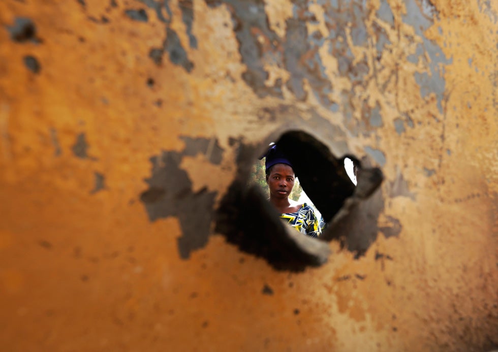 A woman is seen through a bullet hole of a vehicle, believed to belong to Islamist rebels and destroyed during French air strikes, in the recently liberated town of Diabaly, Mali. Eric Gaillard is a Reuters veteran, having worked for the agency since 1985. See more of his work on the <a href="http://blogs.reuters.com/ericgaillard/">Reuters blog</a>.