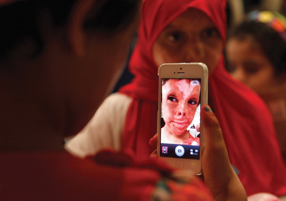 Reuters photojournalist Ali Jarekji made this image of a child snapping a photo with a mobile phone at a party in Amman, Jordan, for Iraqi and Syrian children injured by violence. According to a UN report, half of Syria’s 1.7 million refugees are children, while in Iraq, hundreds of children each year are killed or maimed, typically by improvised explosive devices. In this quiet, personal moment amid the celebration of Eid al-Fitr, the feast that breaks the fast at the end of Ramadan, the child’s nationality is unclear—and irrelevant. Jarekji defines a universal message in a most intimate way.