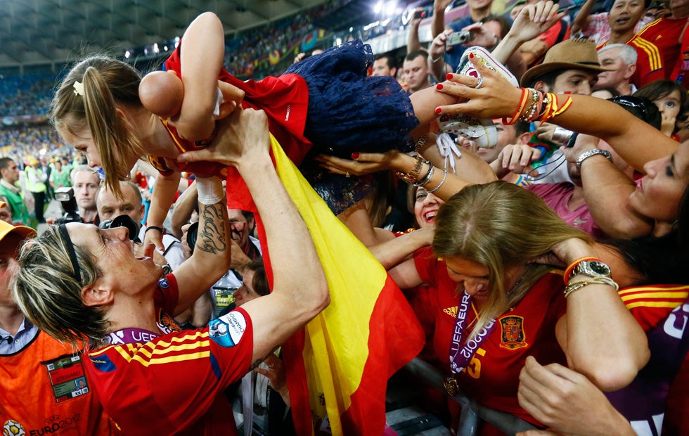 Spain's Fernando Torres (L) celebrates with his daughter Nora after defeating Italy to win the Euro 2012 final soccer match. Kai Pfaffenbach is a Germany-born photojournalist, who began working for Reuters in 1996, before coming on fulltime in 2001. See more of his work on his <a href="http://www.kai-oliver-pfaffenbach.com/">Website</a>. You can also keep up to date with his assignments by checking out his <a href="http://blogs.reuters.com/kai-pfaffenbach/">Reuters blog</a>.