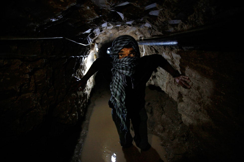 A Palestinian works inside a smuggling tunnel flooded by Egyptian forces, beneath the Egyptian-Gaza border in Rafah. Egypt has been steadily trying to stop the two-way smuggling of arms across its borders, by destroying tunnels like these. Ibraheem Abu Mustafa is a photojournalist based in Gaza, working for Reuters.