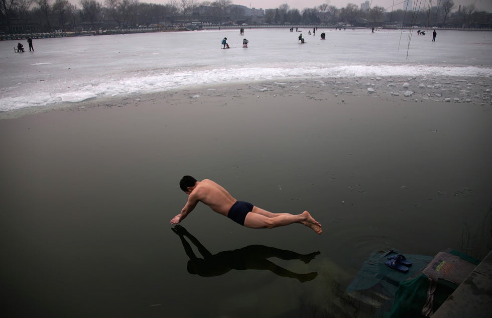 A swimmer dives into the icy water of the Houhai Lake in central Beijing, China. Petar Kujundzic has been shooting for Reuters since 1988. He is currently Chief Photographer for Greater China. See more of his incredible work on the <a href="http://blogs.reuters.com/petar-kujundzic/">Reuters blog</a>.