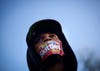 Jajuan Kelley, of Atlanta, wears a Skittles wrapper over his mouth during a rally in memory of Trayvon Martin, the unarmed 17-year-old who was killed by a Florida neighborhood watch captain while returning from a convenience store with a bag of Skittles. David Goldman is a staff photographer for the Associated Press based in Atlanta. You can see more of his work on his <a href="http://www.goldmanphotos.com/">personal site</a>.