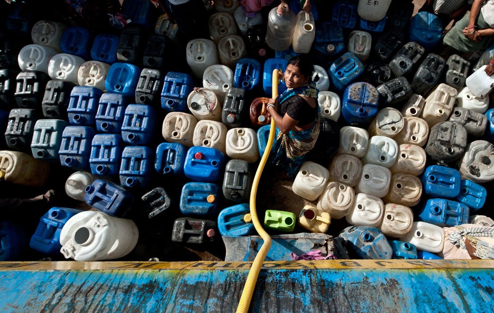An Indian woman fills water containers from a tanker in New Delhi. The city has been struggling with acute water shortages after a neighboring state cut its supplies at the peak of summer. Manan Vatsyayana is a New Delhi-based photographer shooting for AFP. Keep up to date with his work and assignments by following him on <a href="https://twitter.com/#!/mananvatsyayana">Twitter</a>.