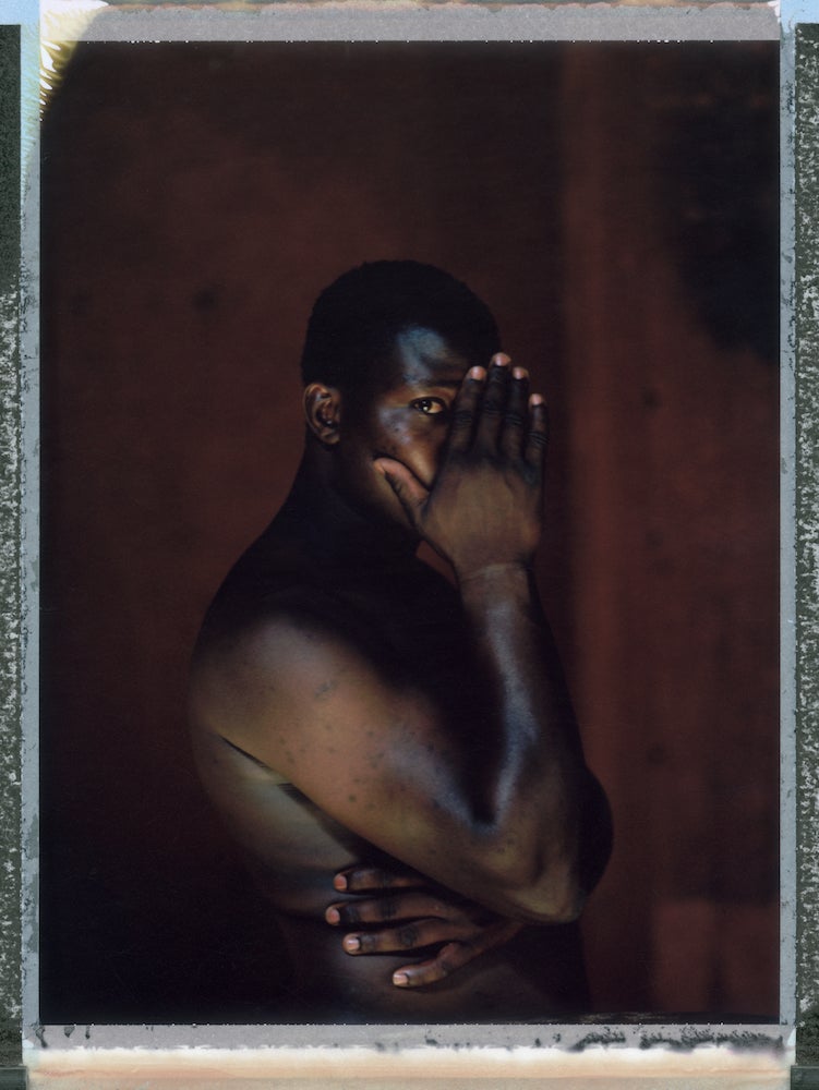 A posed posed portrait of Buje (not his real name) who is gay. In December 2013 he was taken from his home by a vigilante group aligned to Bauchi City Sharia Courts who suspected him of being gay. They slapped him and beat him with electric cables. He was held in prison for over 40 days. He made several appearances at the Sharia Court. After being beaten in prison he confessed to committing homosexual acts. He was lashed 15 times with a horse whip as a punishment. Sodomy is punishable by death under Sharia Law but requires four witnesses. Since Nigeria’s president signed a harsh law criminalizing homosexuality throughout the country, arrests of gay people have multiplied, advocates have been forced to go underground, some people fearful of the law have sought asylum overseas and news media demands for a crackdown have flourished.