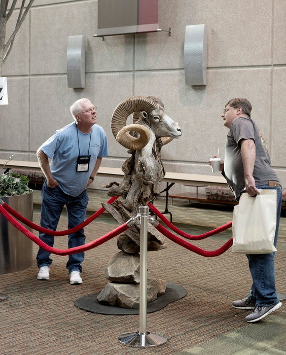 Two unknown participants take a closer look at winner of Best of Category, Collective Artists, Recreations and Replicas FRANK NEWMYER and EARL MARTZ, Gladwin, MI. Marco Polo Sheep