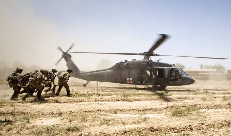 U.S. Army soldiers carry their comrade wounded at patrol by an improvised explosive device (IED) towards a Blackhawk Medevac helicopter in southern Afghanistan June 12, 2012. Picture taken June 12, 2012. REUTERS/Shamil Zhumatov (AFGHANISTAN - Tags: MILITARY CIVIL UNREST POLITICS)