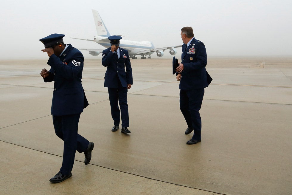 Three U.S. Air Force officers hold onto their hats as Air Force One departs from Joint Base Andrews, Maryland. Jonathan Ernst is a Reuters staff photographer based in Washing DC. Check out more of his incredible work on his <a href="http://www.jonathanernst.com/">personal site</a>.