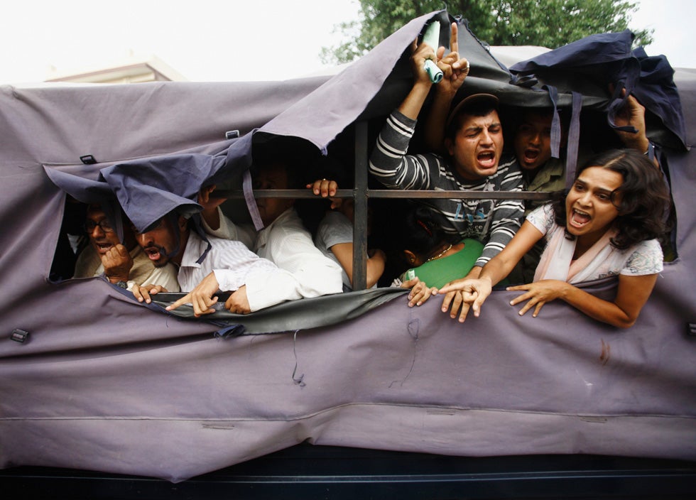 Human Rights and Peace Society activists shout from a police vehicle after getting arrested during a sit-in protest outside Prime Minister Baburam Bhattarai's official residence in Nepal. Navesh Chitrakar is a Reuters staffer based in Nepal. See more of his work on the <a href="http://in.reuters.com/news/pictures/slideshow?articleId=INRTR2TSMC">Reuters blog</a>.