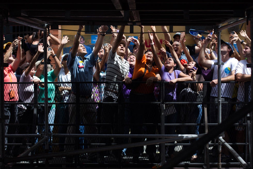 Supporters of opposition candidate Henrique Capriles reach out to him as he greets them during a presidential election rally in Caracas, Venezuela. Carlos Garcia Rawlins is a freelance photographer working for Reuters. He is based out of Caracas, Venezuela. He is also part-time photography teacher at Roberto Mata Tailer de Fotografia in Venezuela. See more of his work on his <a href="http://www.photorawlins.com/">personal site</a>.