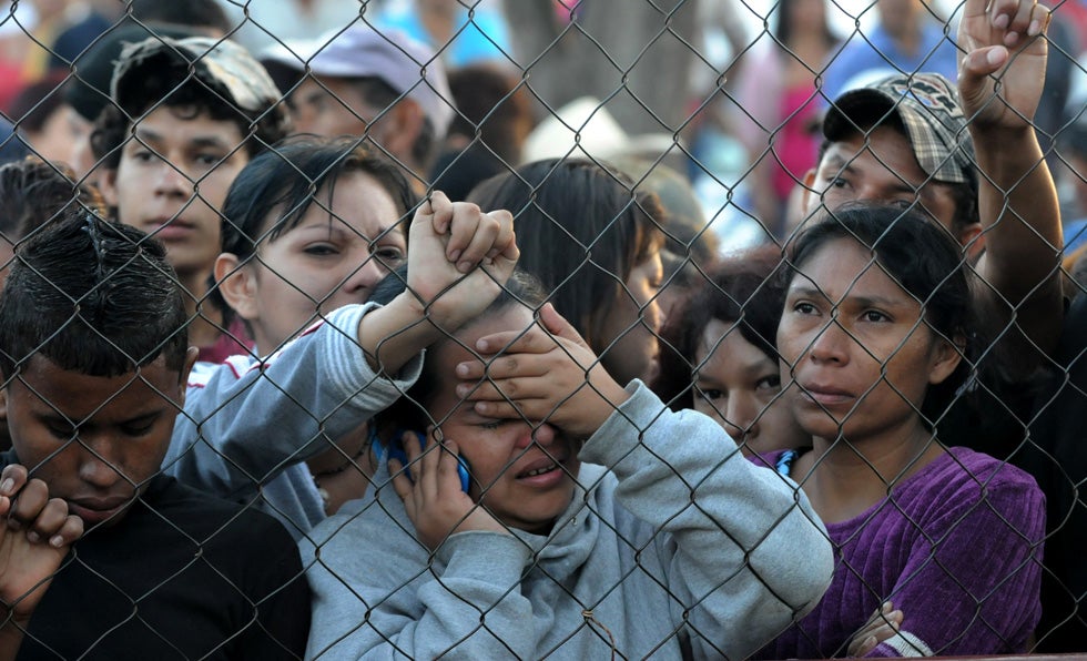 Relatives of inmates at the Comayagua, Honduras prison facility wait outside the compound for news on the status loved ones. AFP staff photographer Orlando Sierra captured this emotional image the day after the fire.