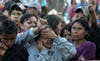 Relatives of inmates at the Comayagua, Honduras prison facility wait outside the compound for news on the status loved ones. AFP staff photographer Orlando Sierra captured this emotional image the day after the fire.