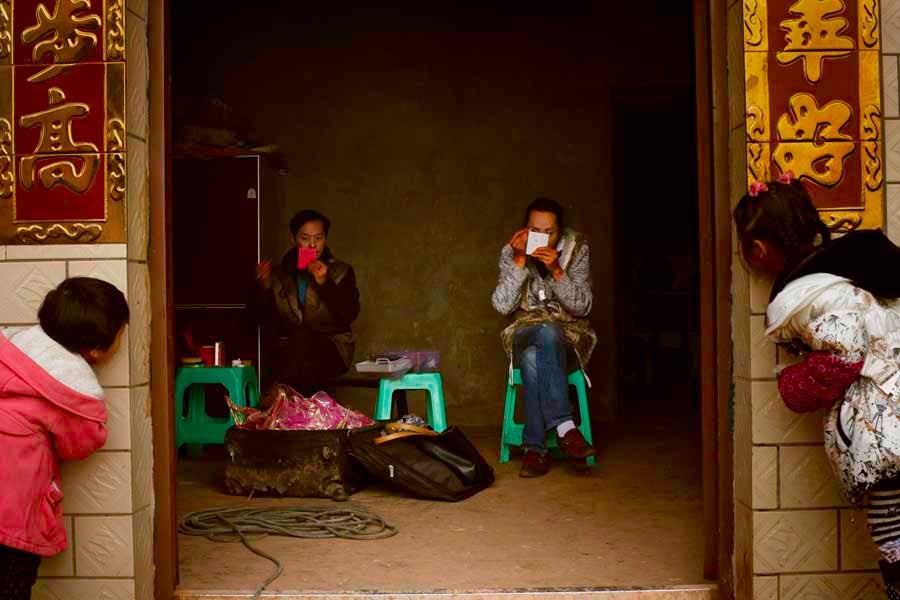 Pandra and Lala putting makeup on at a farmer's house