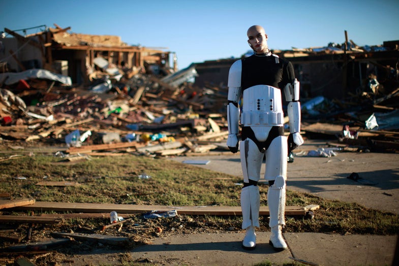 A Star Wars movie character mannequin stands outside a tornado destroyed house in Oklahoma City, Oklahoma May 22, 2013. The owner of the house collected movie memorabilia. Rescue workers with sniffer dogs picked through the ruins on Wednesday to ensure no survivors remained buried after a deadly tornado left thousands homeless and trying to salvage what was left of their belongings. REUTERS/Rick Wilking (UNITED STATES - Tags: DISASTER ENVIRONMENT) - RTXZX95