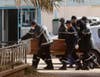 Rescue workers deliver a coffin containing the body of one of the hostages killed during a four-day siege at an Algerian gas plant to a local hospital. The hostage death toll has risen to almost 60 in an attack claimed by veteran Islamists fighter on behalf of al Qaeda. Ramzi Boudina is a stringer working for Reuters in Algeria.