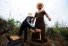 Chinese honeybee farmer She Ping covers himself with bees at his farm in China’s Southwest Chongqing municipality in a world-record-breaking attempt. Ping, with the help of an apprentice, successfully covered himself in 33.1 kilograms or about 331,000 bees. The previous world record was 26.8 kilograms of bees.