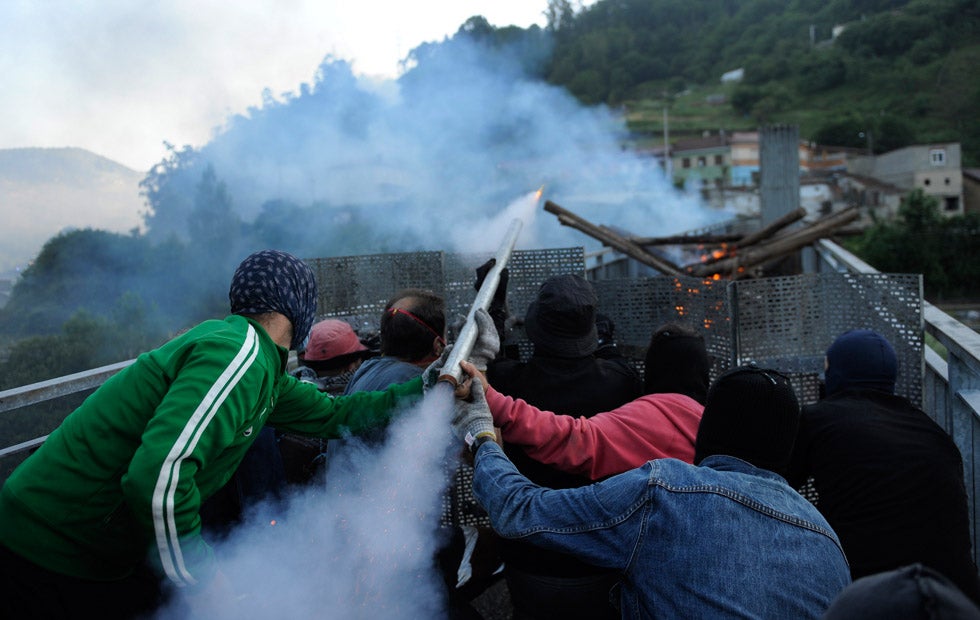 Coal miners fire a rocket during a clash with Spanish national riot police in the surroundings of the "El Soton" coal mine in El Entrego, Spain. Protests over a government proposal to decrease funding for coal production recently turned violent. Eloy Alonso is a Reuters staffer based in Spain.