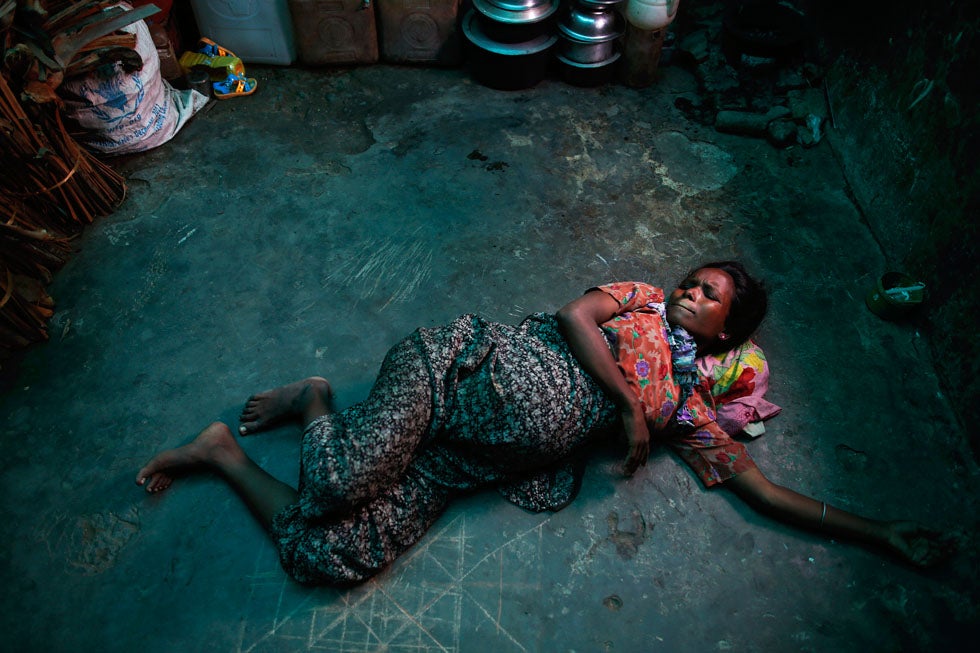 Roma Hattu, a Rohingya Muslim woman who is nine months pregnant and is displaced by violence, grimaces while experiencing labor pains on the bare floor of a former rubber factory now serving as her family's shelter near Sittwe, Myanmar. Damir Sagolj is a Reuters staff photographer based in Myanmar. See more of his work <a href="http://www.americanphotomag.com/photo-gallery/2013/02/photojournalism-week-february-22-2013">here</a>.