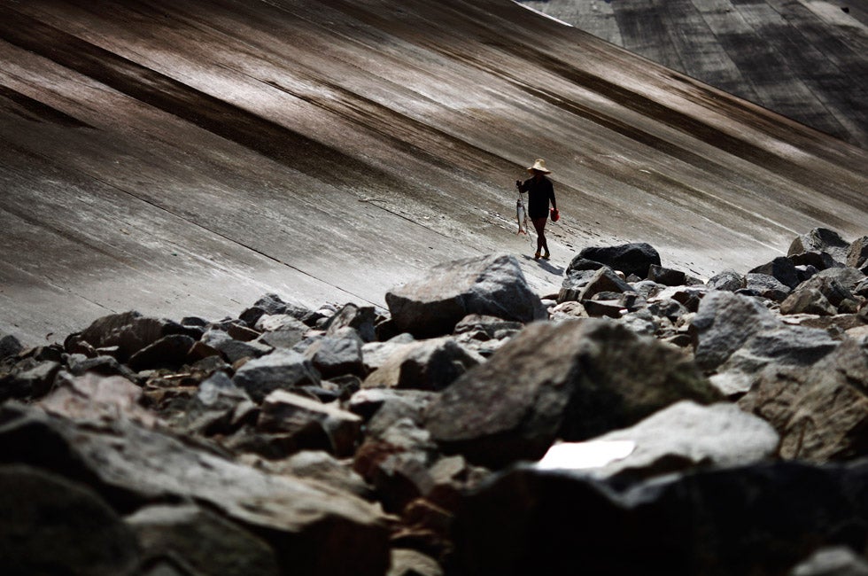 A fisherman walks with his catch on the banks of the Yangtze River, near the controversial Three Gorges dam in Yichang, Hubei province, China. Carlos Barria is an Argentinean photographer who moved to China in 2010 to document daily life there for Reuters.