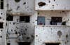 A Palestinian man stands on the balcony of his destroyed house as he waits for the visit of Palestinian Prime Minister Rami Hamdallah to Gaza's neighborhood of Shijaeyih, Thursday, Oct. 9, 2014. Members of the new Palestinian unity government assembled in Gaza for their first Cabinet session in the war-battered territory—a largely symbolic meeting meant to mark the end of absolute Hamas control of the coastal strip. Khalil Hamra has worked with AP since 2002. He was awarded the Overseas Press Club of America Robert Capa Gold Medal in 2010. See more of his work <a href="http://www.apimages.com/Collection/Landing/Photographer-Khalil-Hamra-/974135ffb40646d9923f5d9c853173d7">here.</a>