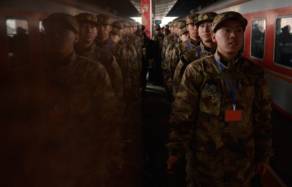 New recruits for the People's Liberation Army line up waiting to board a train at Taiyuan railway station. Jon Woo is a photojournalist based in China, shooting for Reuters.