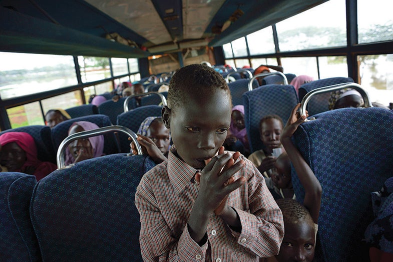 Gasim Muhammed stands in the aisle of a UNHCR bus transporting him to his new home in Yusuf Batil camp after weeks of squatting in temporary sites with his family. Thirty thousand men, women and children from Sudan’s Blue Nile State sought an end to nine months of terror and trauma when they crossed the border into neighboring South Sudan in June 2012, becoming refugees for the first time in their lives. They joined a population of 70,000 who preceded them in fleeing Khartoum’s deadly military campaign to crush the northern remnant of the Southern liberation movement. The journey, made perilous by the dearth of water and food as well as the risk of ambush and attack, required weeks of walking after months of internal displacement.
