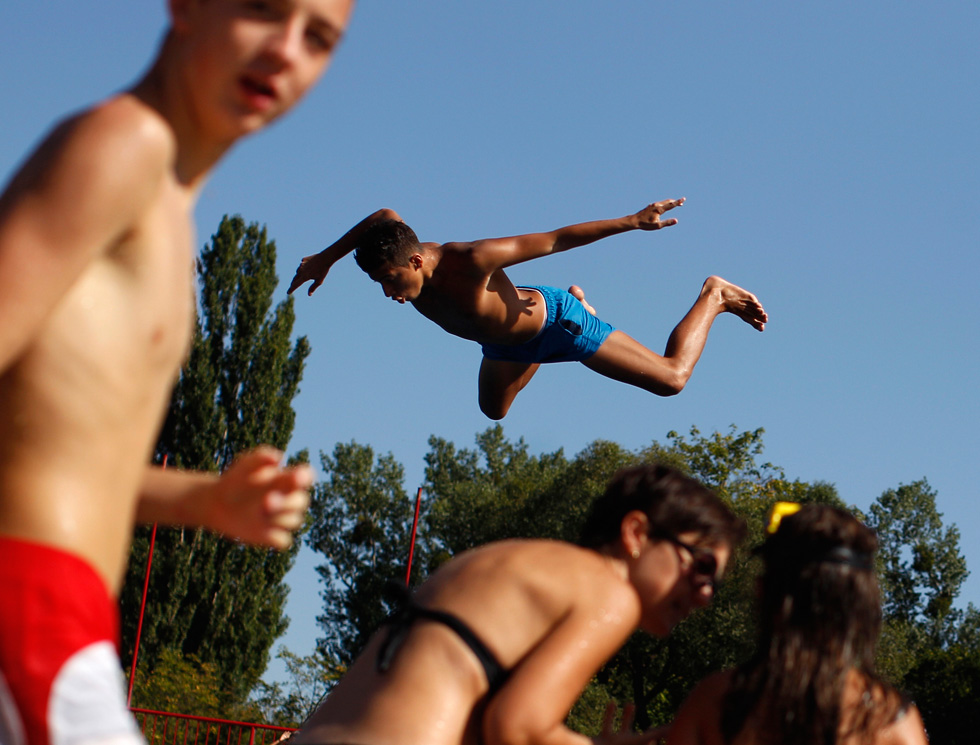 Children jump into a swimming pool to keep cool in Vienna, Austria, during a heat wave earlier in the week. Lisi Niesner in an Austrian-based photojournalist shooting for Reuters. Keep up to date with her assignments by following her <a href="http://twitter.com/LisiNiesner">Twitter feed</a>.